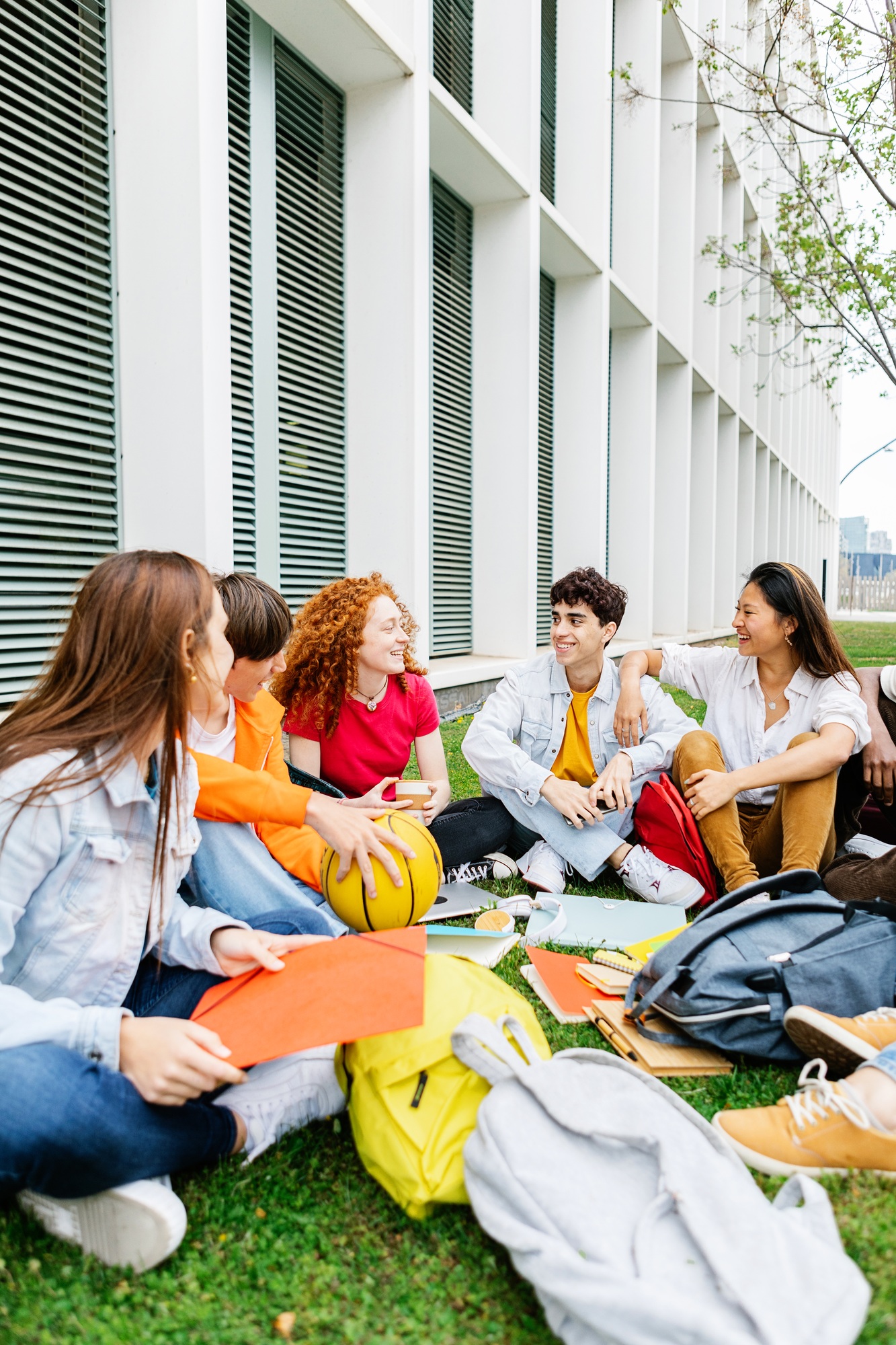 Students sitting on the grass of the campus